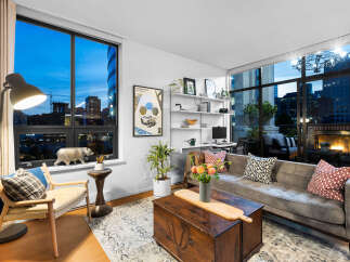 Experience modern city living in this stunning apartment featuring expansive windows with breathtaking city views.