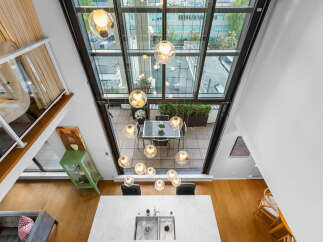 Experience luxury living in this stunning loft with soaring ceilings and a wall of windows offering breathtaking city views.