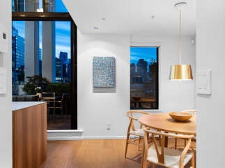 Experience modern urban living with this stunning apartment featuring a spacious dining area and a private balcony overlooking the city skyline.