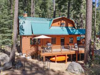 Experience the ultimate mountain getaway in this charming cabin nestled among tall pine trees.