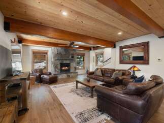 Experience rustic charm in this inviting living room, featuring a magnificent stone fireplace as the centerpiece.