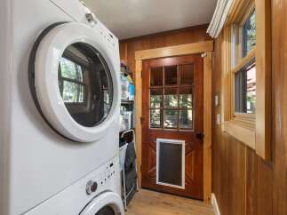 This laundry room features a stacked white washer and dryer, perfect for maximizing space.