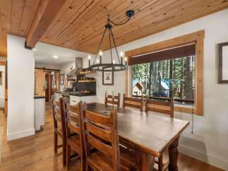 Experience rustic charm in this dining area featuring a large wooden table and chairs, perfect for family gatherings.