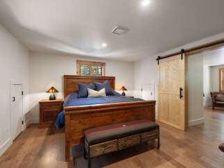 Experience rustic charm in this inviting bedroom, featuring a sturdy wooden bed frame and coordinating nightstands.