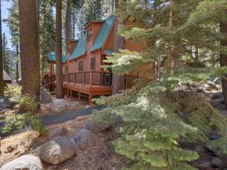 Nestled amidst tall pine trees, this charming wooden cabin offers a serene mountain retreat.