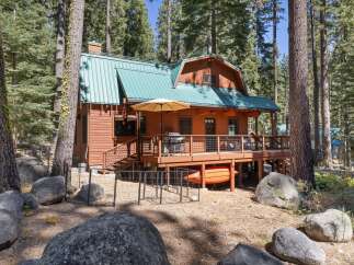 Escape to this charming cabin nestled among tall pine trees, offering a serene mountain retreat.