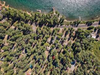 Discover this charming lakeside retreat nestled among tall pine trees, offering a serene escape with direct access to the water.