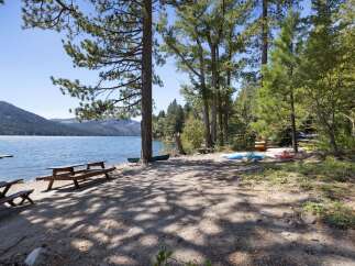 Enjoy lakeside living with this stunning property featuring a serene beach area perfect for launching kayaks and paddleboards.