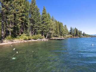 Experience serene lakefront living with this stunning property, featuring a private dock perfect for your boat and water activities.