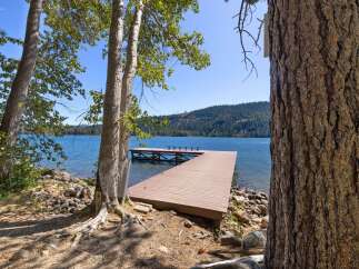 Enjoy serene lakefront living with this stunning property featuring a spacious private dock perfect for swimming, boating, or simply relaxing by the water.