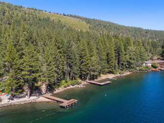 Experience lakeside living at its finest with this stunning property featuring multiple private docks perfect for your watercraft.