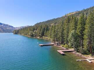 Experience serene lakeside living with this stunning property featuring multiple private docks perfect for your boats and water toys.