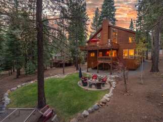 Experience the ultimate mountain retreat with this stunning wooden home nestled amongst tall pine trees.