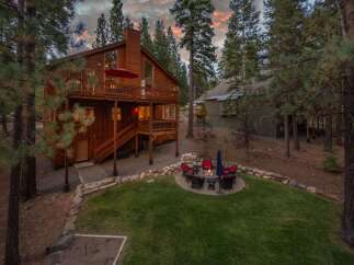 Experience mountain living in this stunning wooden home nestled among tall pine trees.