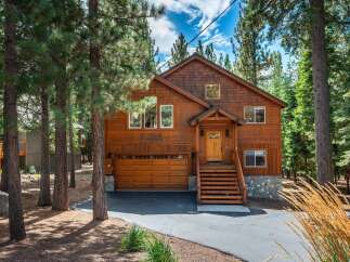 Nestled among tall pine trees, this charming wooden cabin offers a serene mountain retreat.