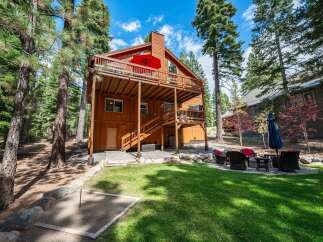 Experience the ultimate mountain getaway in this stunning wooden cabin, nestled amongst tall pine trees.