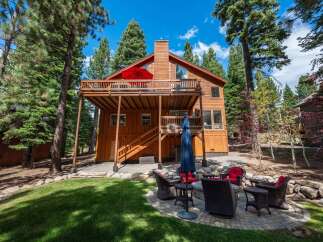 Experience mountain living in this stunning wooden home, nestled amongst tall pine trees.
