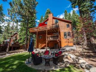 Experience the ultimate mountain retreat with this stunning wooden home, nestled amongst towering pine trees.