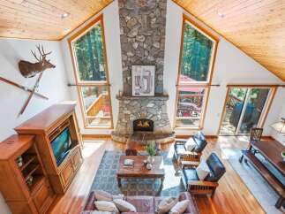 Experience rustic charm in this mountain retreat, featuring a grand stone fireplace as the centerpiece of the living area.