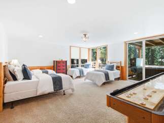 This spacious bedroom offers comfortable sleeping arrangements with three twin beds, perfect for families or groups.