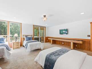 This spacious room offers comfortable sleeping arrangements with multiple beds, perfect for families or groups.