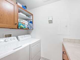 This laundry room features a convenient stacked washer and dryer setup, perfect for maximizing space.