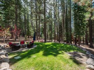 Enjoy outdoor living in this stunning backyard oasis, complete with a cozy fire pit seating area and a dedicated horseshoe pit for endless entertainment.