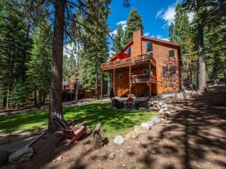 Experience the ultimate mountain retreat in this stunning wooden home, nestled amongst towering pine trees.