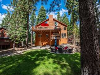 Nestled amongst tall pine trees, this charming wooden home offers a serene mountain retreat.
