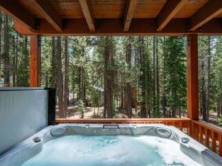 Indulge in ultimate relaxation with this luxurious hot tub, perfectly situated on a private deck amidst a serene forest setting.