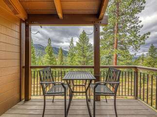Enjoy breathtaking mountain views from this charming covered deck, perfect for morning coffee or evening relaxation.