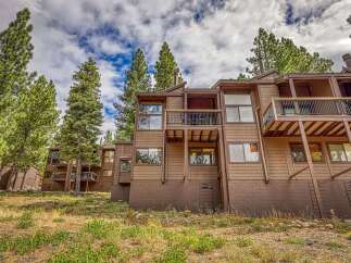 Nestled amidst tall pine trees, this multi-level mountain home offers a serene retreat with stunning natural surroundings.