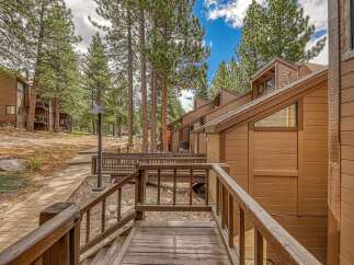 Experience mountain living in this charming property nestled among tall pine trees.