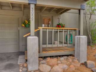 Welcome to this charming home featuring a welcoming porch with vibrant hanging flower baskets.