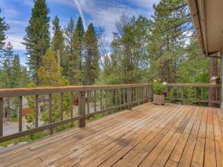 Enjoy the serene mountain views from this expansive wooden deck, perfect for outdoor entertaining or quiet relaxation.