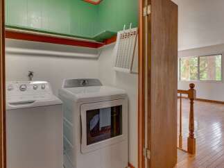 Discover convenience with this in-home laundry area, featuring a top-load washer and a front-load dryer.