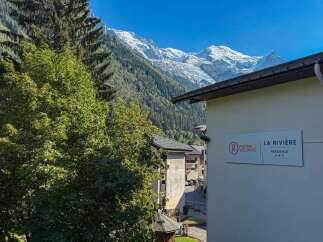 Experience the charm of mountain living at La Rivière residence, offering stunning views of snow-capped peaks and lush green valleys.