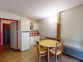 This charming apartment features a well-equipped kitchenette with a refrigerator, microwave, and ample cabinet space, perfect for preparing meals.