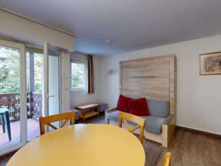 This charming studio apartment features a murphy bed that folds away to reveal a comfortable living space.