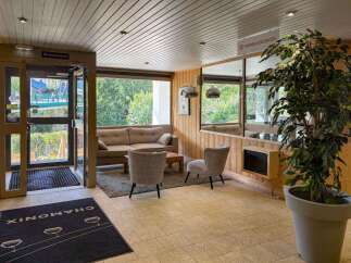Welcome to this charming reception area, featuring a comfortable seating arrangement with a sofa and accent chairs, perfect for guests to relax.