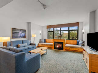 Experience cozy living in this inviting living room, featuring a beautiful fireplace as the centerpiece.