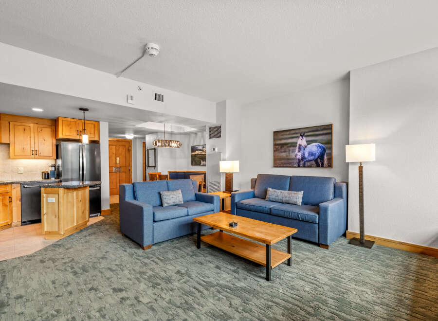 Experience comfort and style in this inviting living space, featuring two plush blue sofas perfect for relaxation.