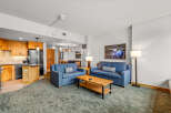 Experience comfort and style in this inviting living space, featuring two plush blue sofas perfect for relaxation.