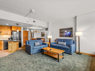 Experience comfort and style in this inviting living space, featuring two plush blue sofas perfect for relaxation.