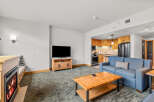 Cozy living room featuring a gas fireplace and a comfortable blue sofa, perfect for relaxing after a day on the slopes.