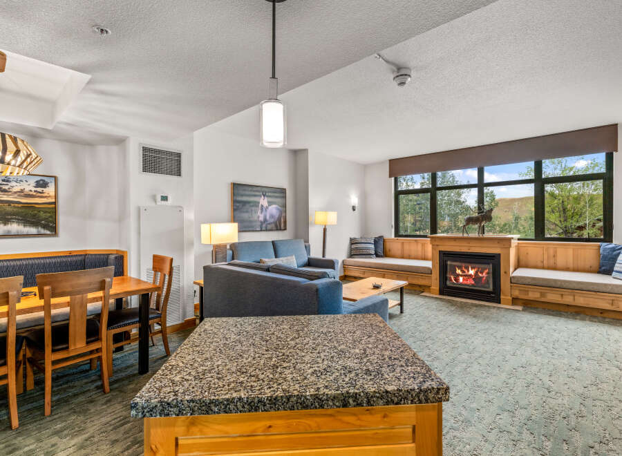 Experience cozy living in this spacious suite featuring a charming fireplace and ample seating.