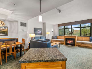 Experience cozy living in this spacious suite featuring a charming fireplace and ample seating.