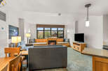 Cozy living room featuring a gas fireplace and large windows with scenic views.