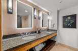 This luxurious bathroom features a spacious double vanity with granite countertops and modern fixtures, perfect for any morning routine.