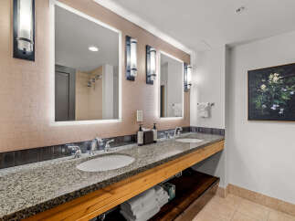 This luxurious bathroom features a spacious double vanity with granite countertops and modern fixtures, perfect for any morning routine.